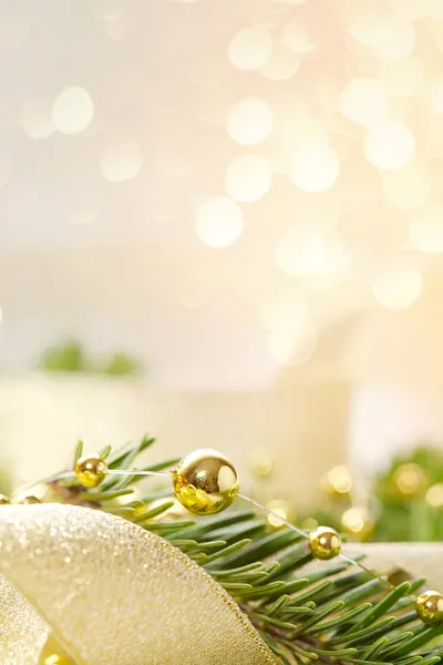 Christmas seasonal background with spruce and golden beads — Stock Photo, Image