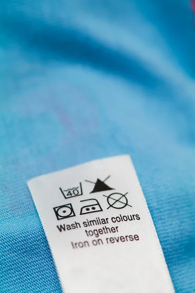 Clothing label with laundry care instructions — Stock Photo, Image