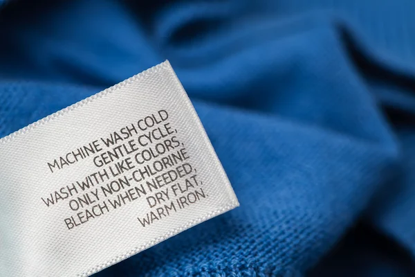 Clothing label with laundry care instructions — Stock Photo, Image