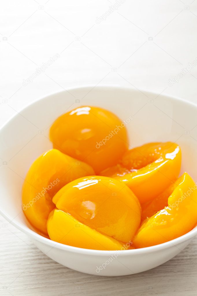 Canned peaches in white plate