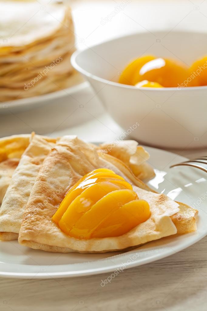 Pancakes with peaches served