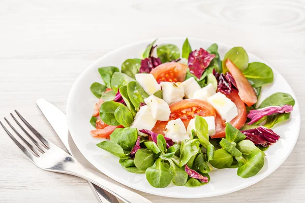 Fresh summer salad on white table — Stock Photo, Image