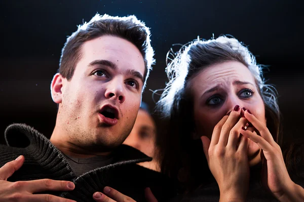 Couple scared at the cinema, watching horror movie — Stock Photo, Image