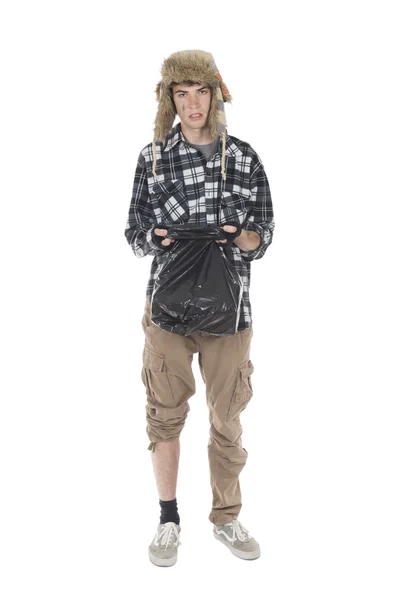 Homeless wanderer with a garbage bag in hand — Stock Photo, Image