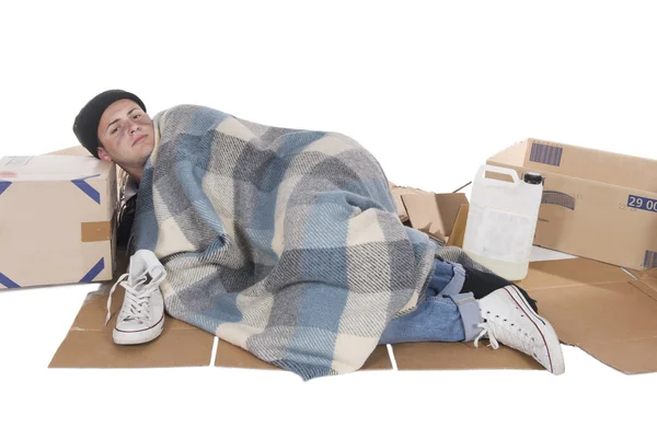 Homeless lying on cardboard — Stock Photo, Image