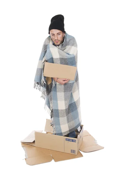 Homeless in his cardboard begging with a sign — Stock Photo, Image