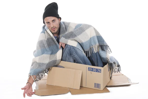 Homeless man sitting in his cardboard begging — Stock Photo, Image