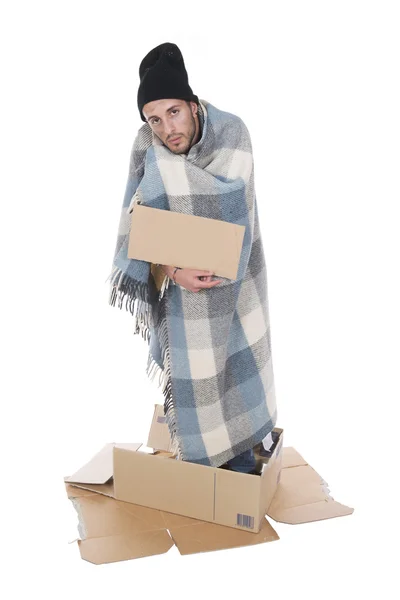 Homeless in his cardboard begging with a sign — Stock Photo, Image
