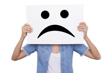 Young girl holding a sign with a sad smiles face front of her clipart