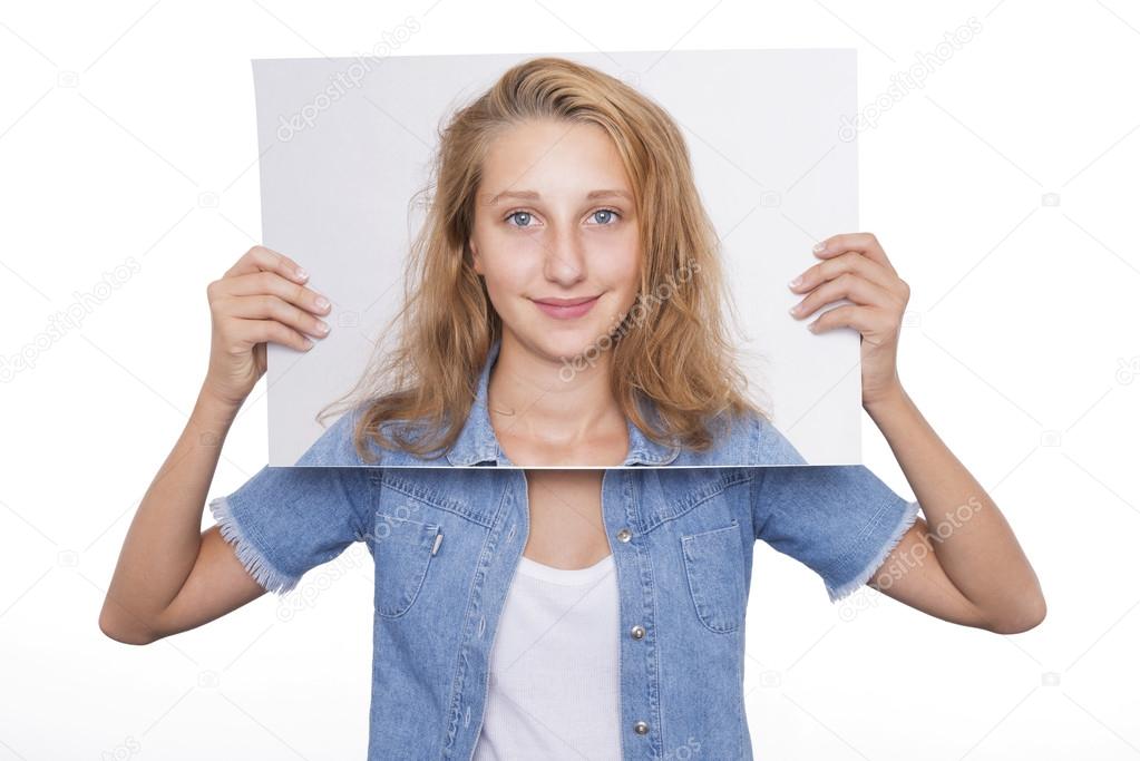 Girl holds her picture in front of her face
