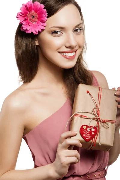 Brunette girl holding gift box — Stock Photo, Image