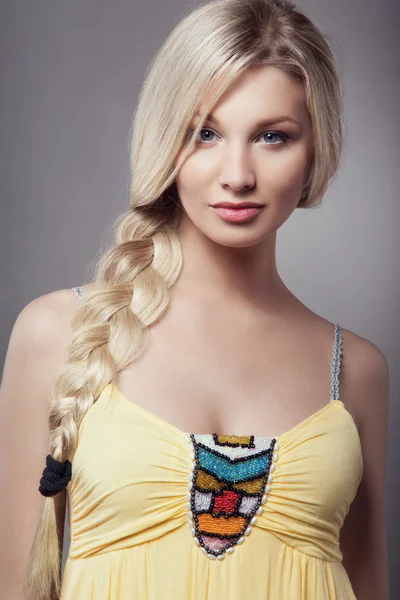 Blonde young woman with braid hairdo — Stock Photo, Image