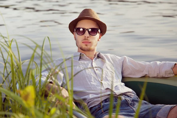 Young man resting in boat — Stock Photo, Image