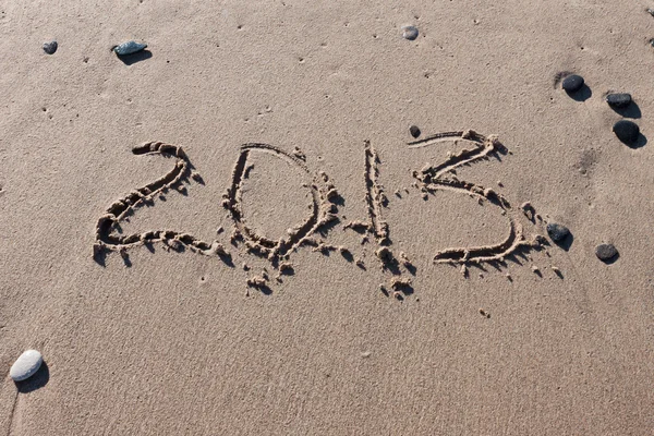 Números 2012 na areia da praia para o ano civil — Fotografia de Stock