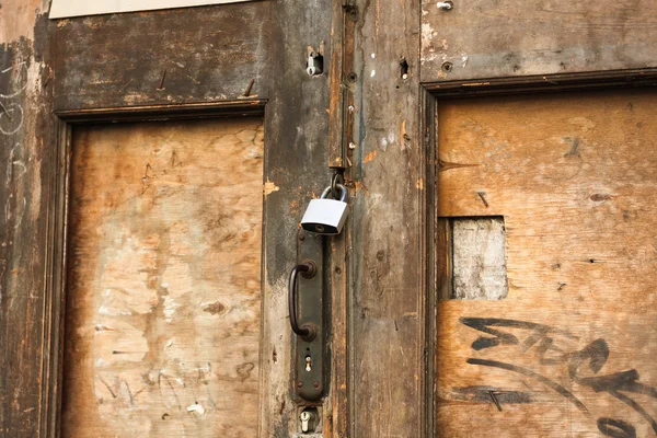 Old wooden door with locks — Stock Photo, Image