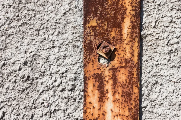 Rusty metal on plaster concrete wall — Stock Photo, Image
