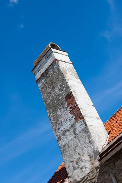 Old brick chimney on orange tile roof — Stock Photo, Image