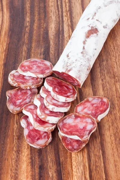 Salami sausage on wooden background — Stock Photo, Image