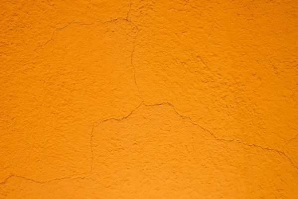 Orange cracked plaster wall — Stock Photo, Image
