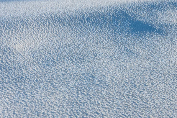 Textura bílého sněhu s modrými stíny — Stock fotografie