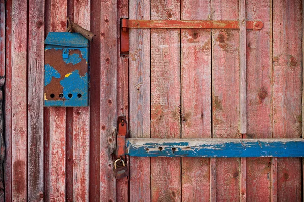 Old mailboxe on an old wooden door — Stock Photo, Image