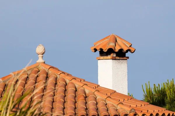 Small statue on the red tiled roof — Stock Photo, Image