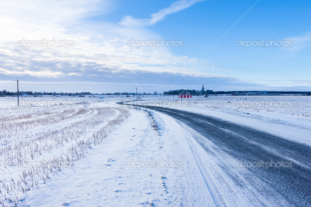 Countryside road through winter field