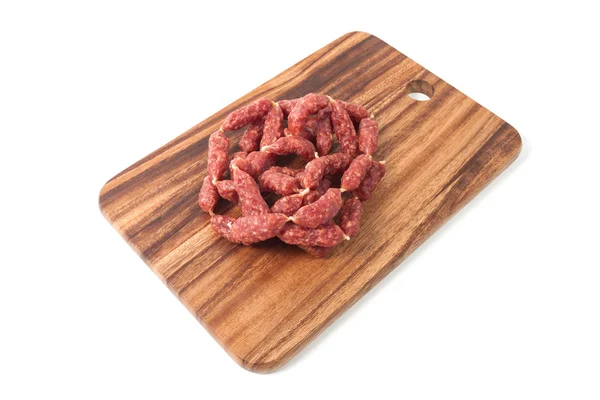 Een hoop van mini salamis op houten bord — Stockfoto