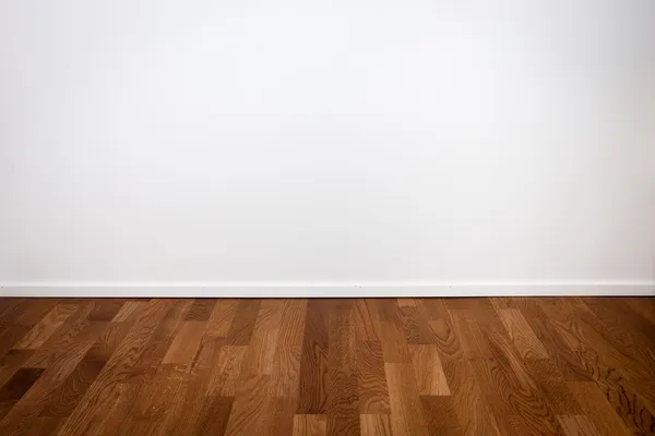 Empty white wall and wooden floor — Stock Photo, Image