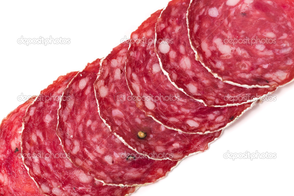 Slices of salami sausage on a white background