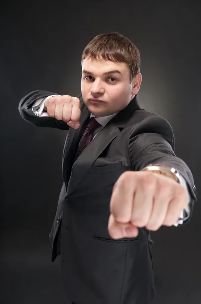 A young man in a suit standing in front boxer. — Stock Photo, Image