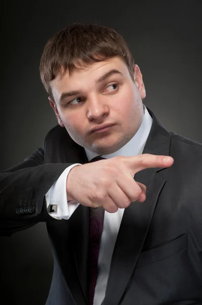 Business man shows his finger to the side — Stock Photo, Image