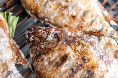 Salted and stuffed fish for sale in Northern Thailand on a grill in iopen market