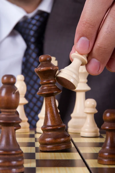 Businessman Holding Pawn Against King — Stock Photo, Image