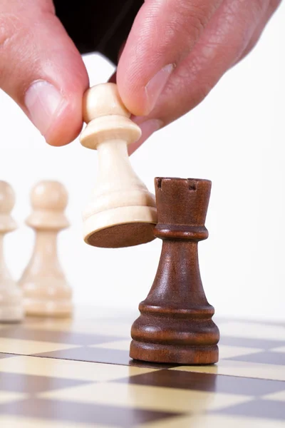 Hand Holding Pawn Against Castle — Stock Photo, Image