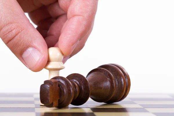 Hand Holding Pawn Against King — Stock Photo, Image