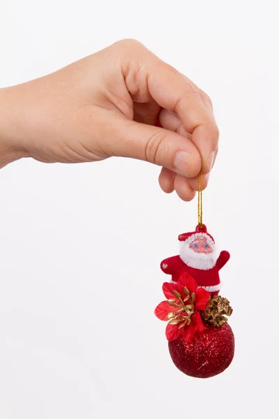 Hand met speelgoed van de Kerstman — Stockfoto