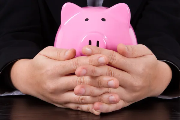 Business Woman Covering Piggy Bank — Stock Photo, Image