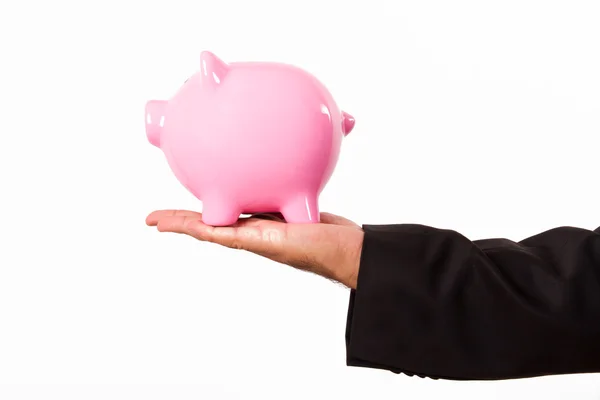 Piggy bank holding met de zakenman hand — Stockfoto