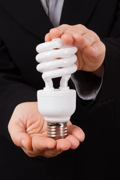 Business Woman Holds Economical Lightbulb — Stock Photo, Image