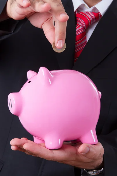 Coin Into Piggy Bank — Stock Photo, Image