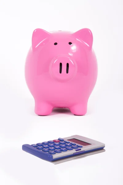 Roze piggy bank en rekenmachine Stockfoto