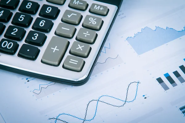 Calculator on Financial Data Graphs — Stock Photo, Image