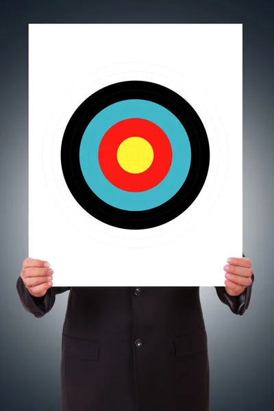 Geschäftsmann hält Plakat mit Zielscheibe in der Hand — Stockfoto