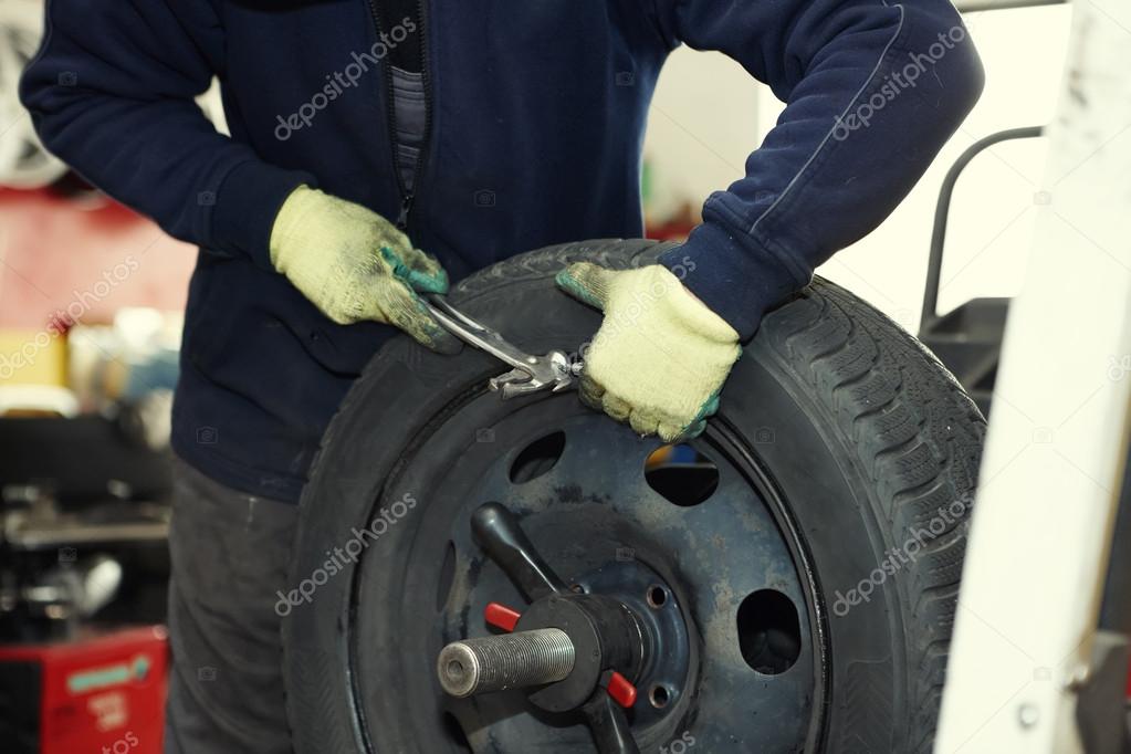 Changing a tire in a garage