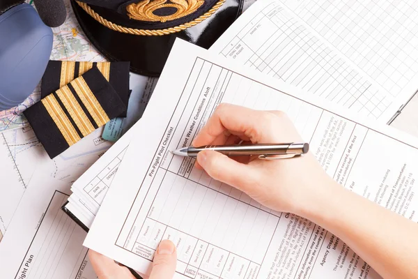 Airplane pilot filling in flight plan — Stock Photo, Image