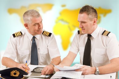 Airline pilots filling in papers in ARO