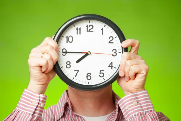 Clock covering face Stock Image