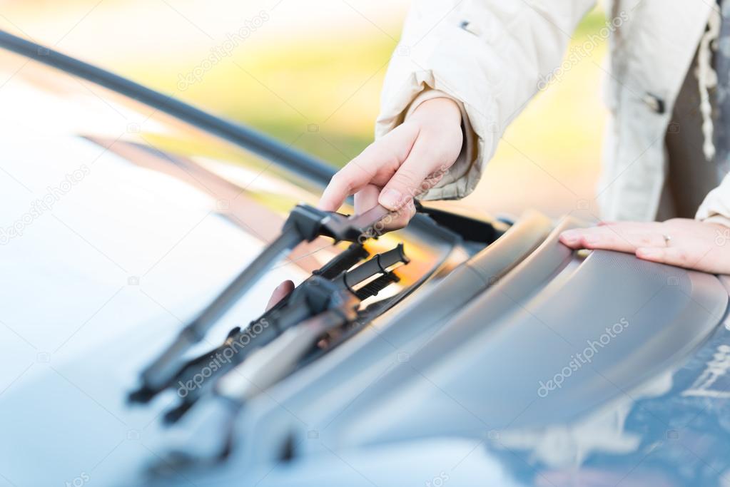 Hand picking up windscreen wiper