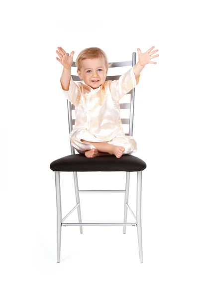 Adorable baby girl sitting on a chair — Stock Photo, Image